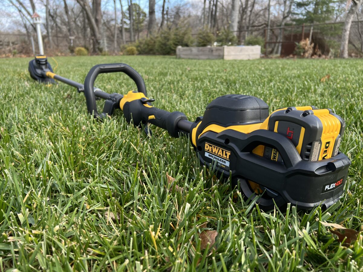full length view of the dewalt 60v max string trimmer sitting in grass
